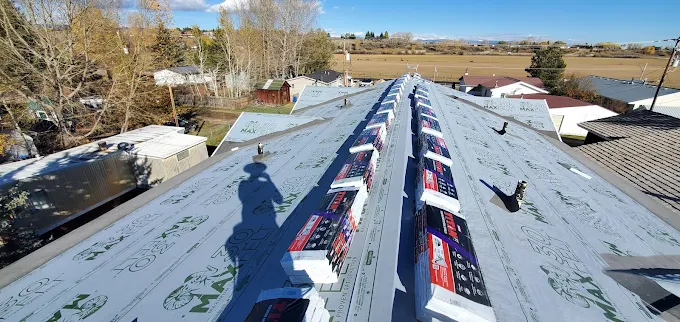 Roof deck prepared with underlayment and shingle bundles