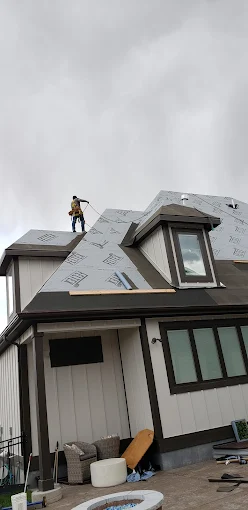 Roofer working on steep roof underlayment